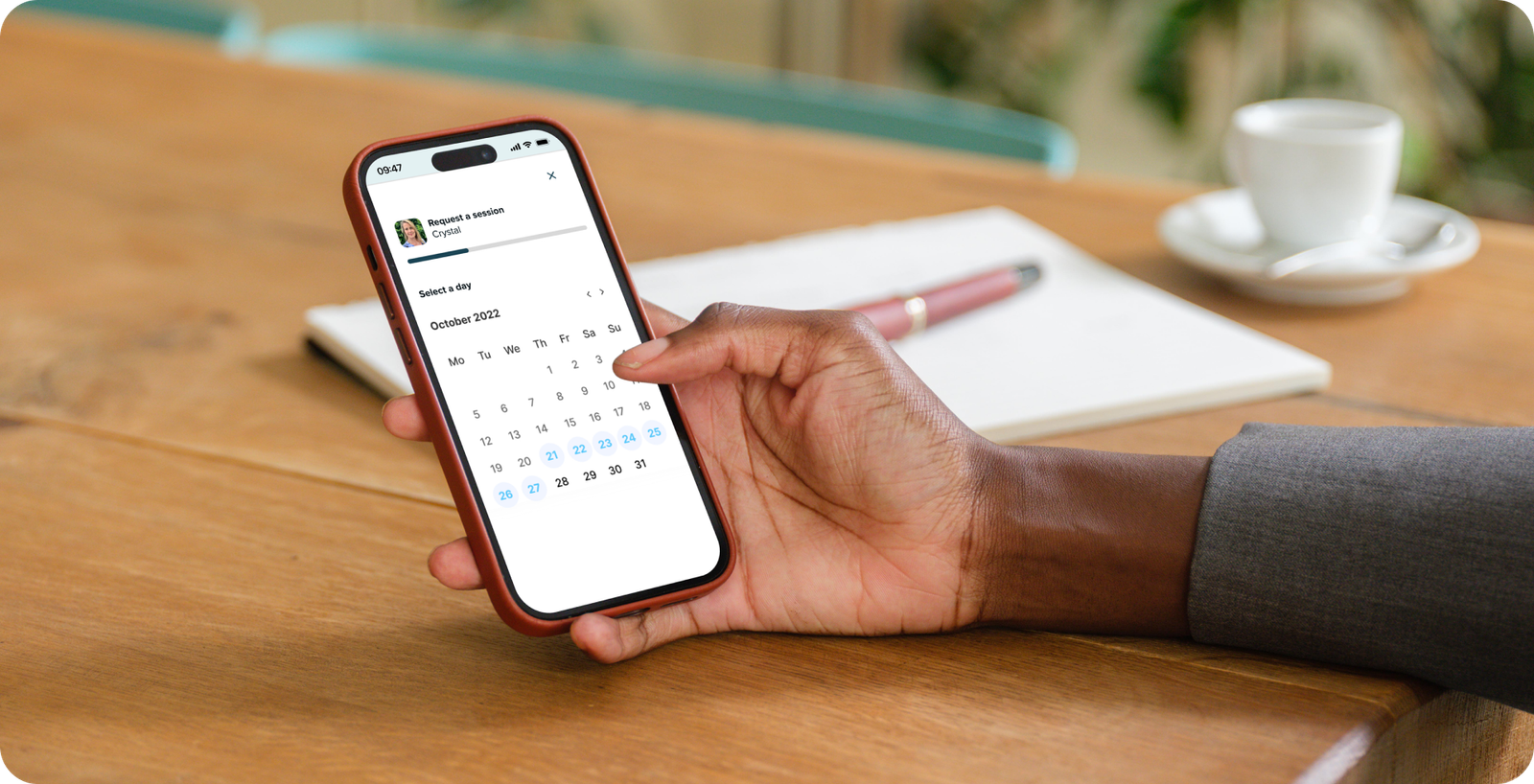 Female-entrepreneur-in-office-with-iPhone-in-her-hand-Mockuuups-Studio-1